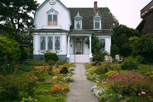 Idyllic Victorian-style home surrounded by a vibrant garden in a serene setting.